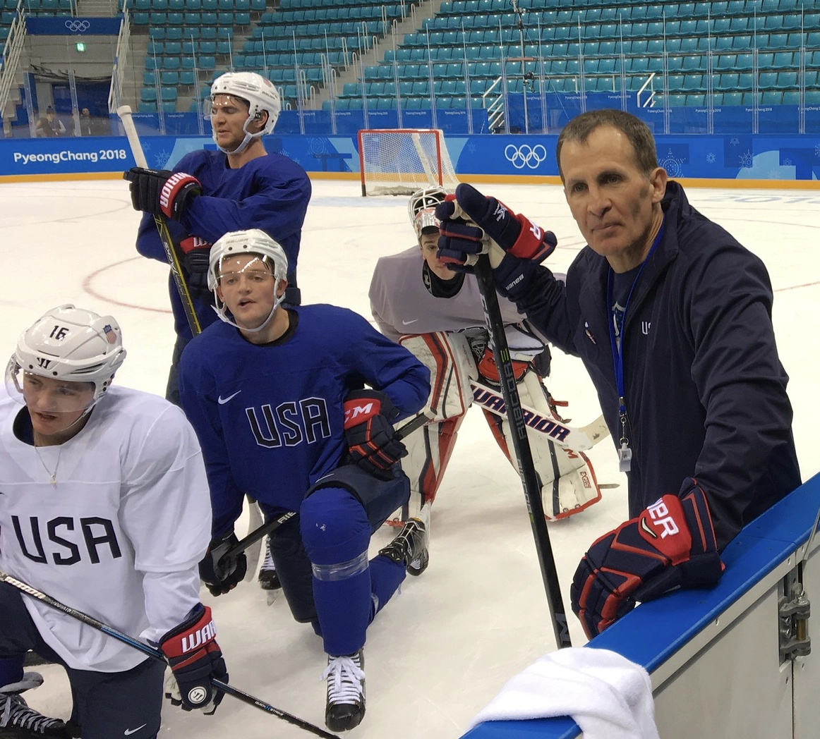 Olympic coach Tony Granato poses with USA hockey players.